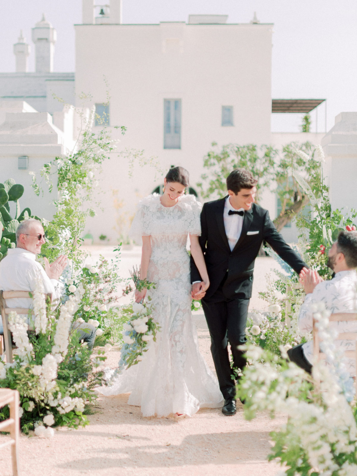 Bride and groom walking down aisle after wedding ceremony in Polignano Puglia