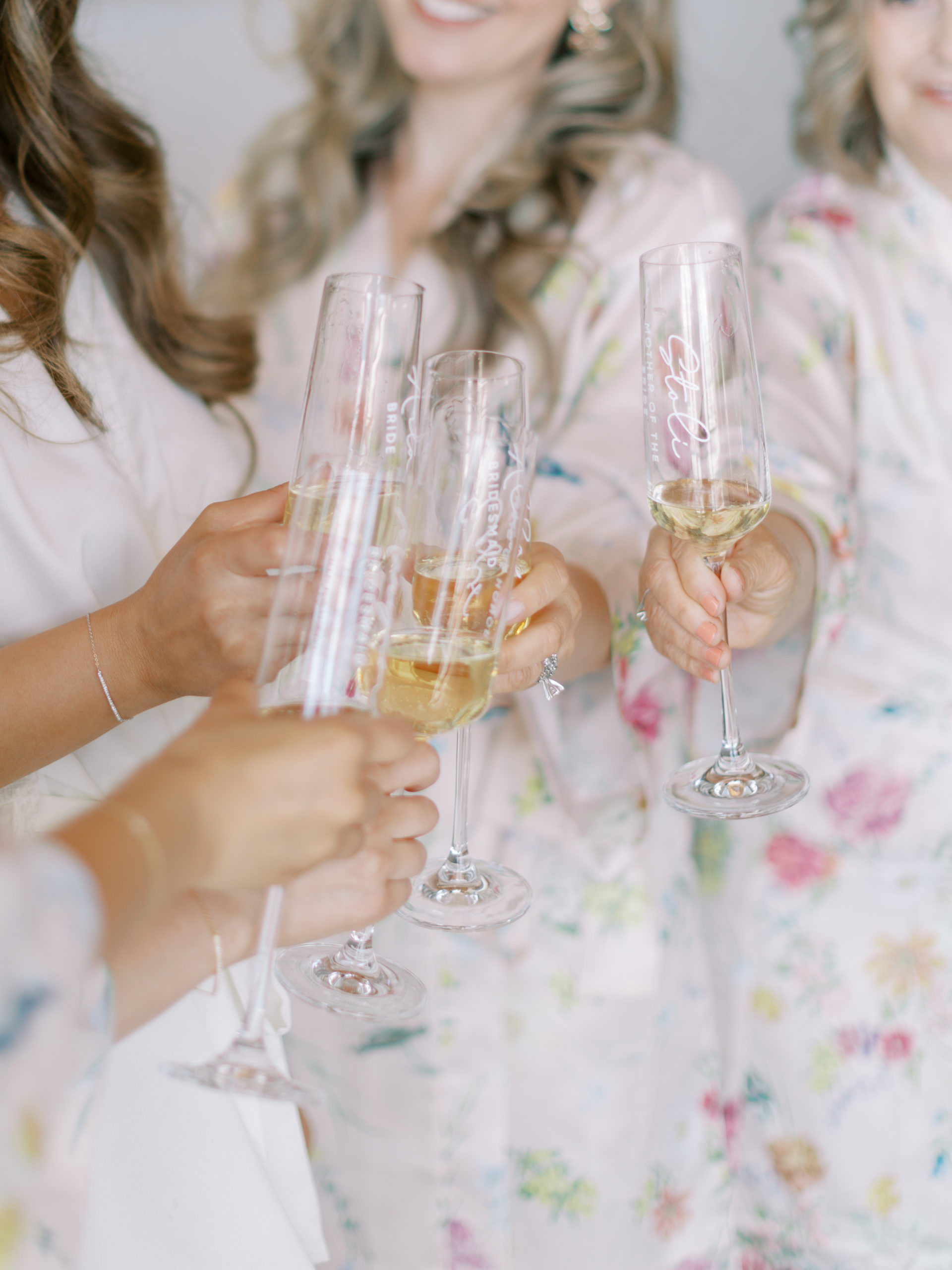 bride and bridesmaids celebrating with champagne