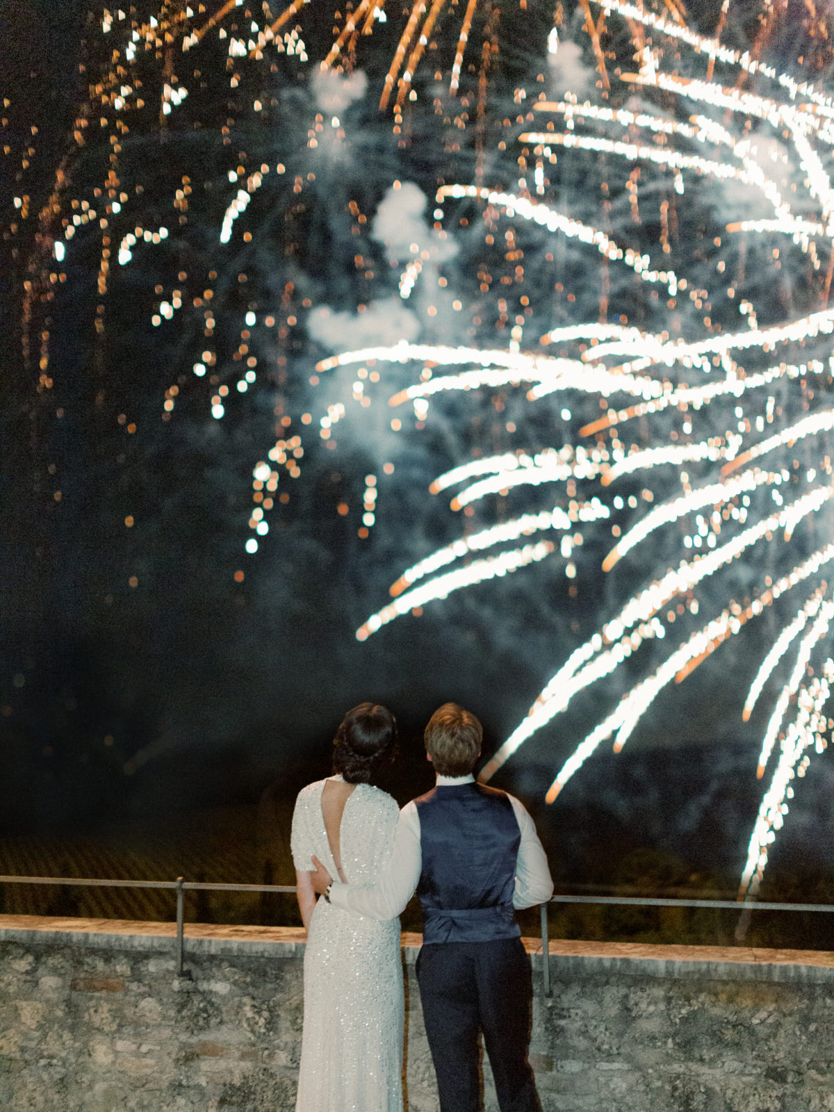 Bride and groom watching fireworks at wedding on Lake Como
