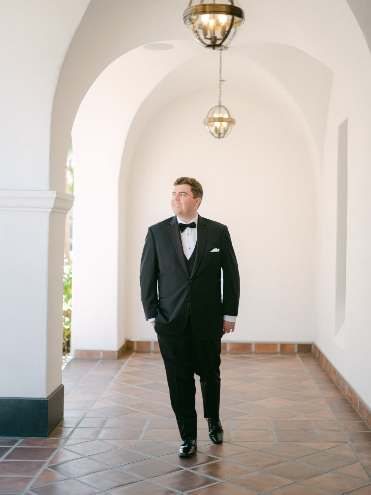 groom wearing black tuxedo in santa barbara at californian hotel