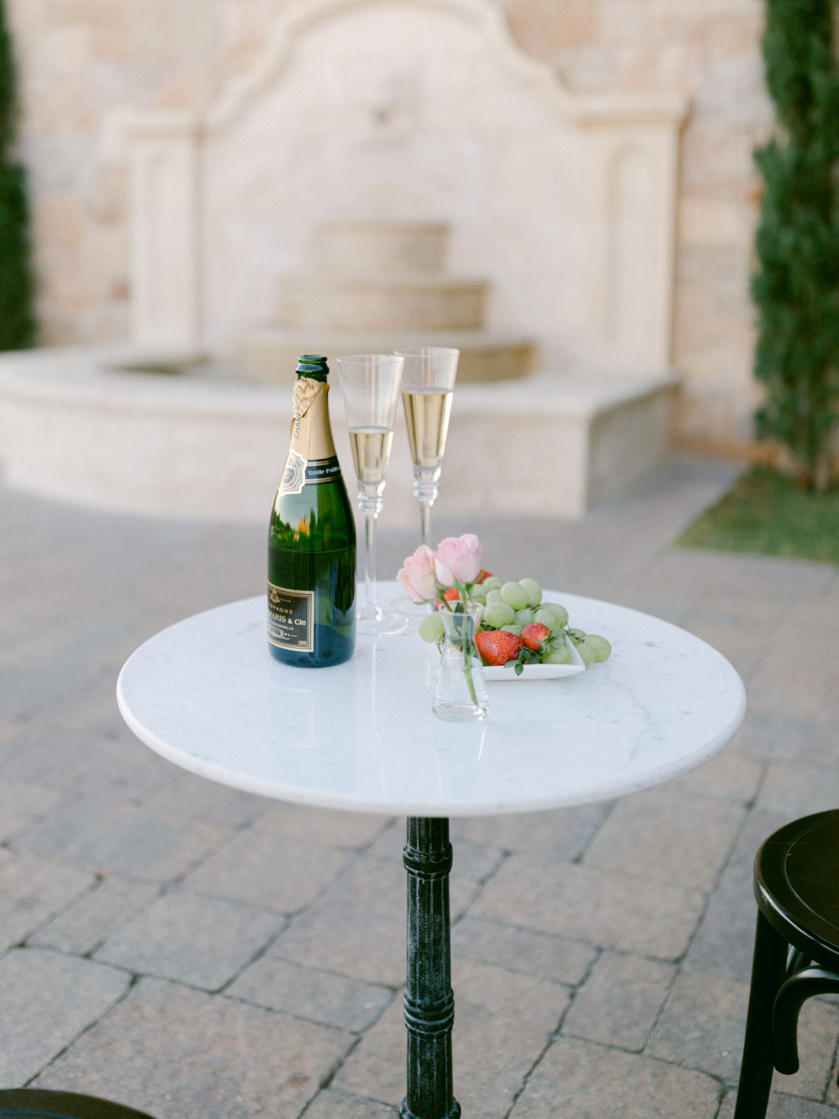 champagne and glasses on a bistro table