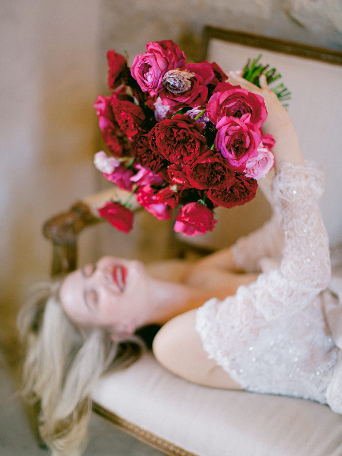 Happy woman holds a bouquet of red roses
