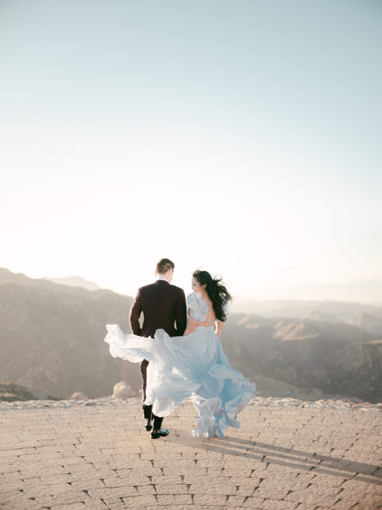 wedding film photography of a bride and groom on a cliff in Malibu