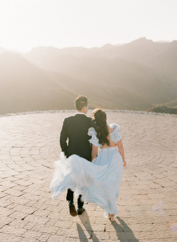 film photography at a wedding of a couple walking toward the sunset